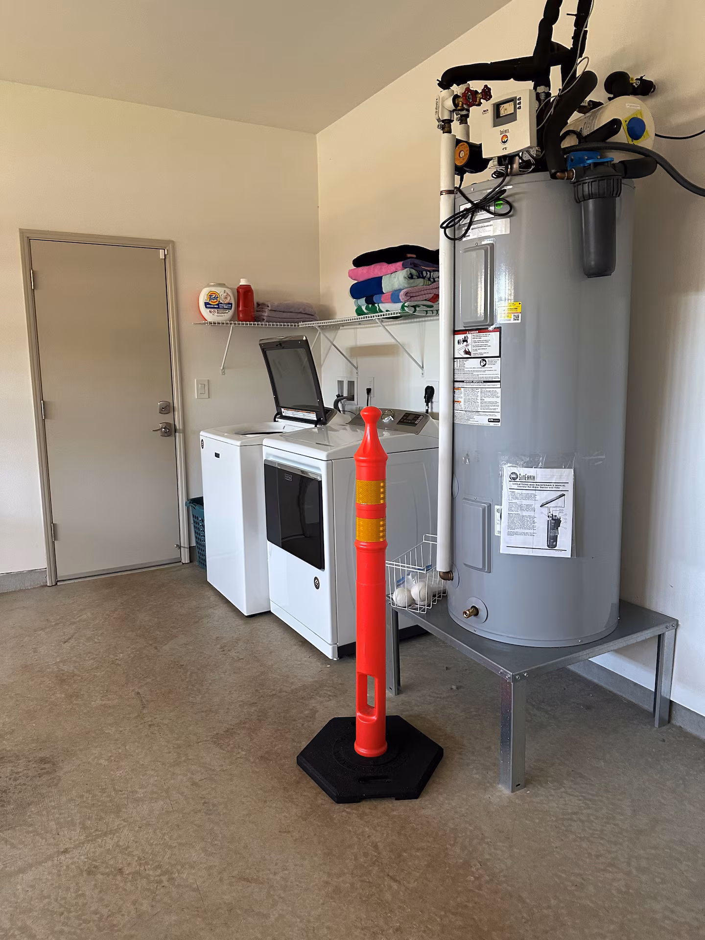 Garage utility area with the washer, dryer and solar hot water tank