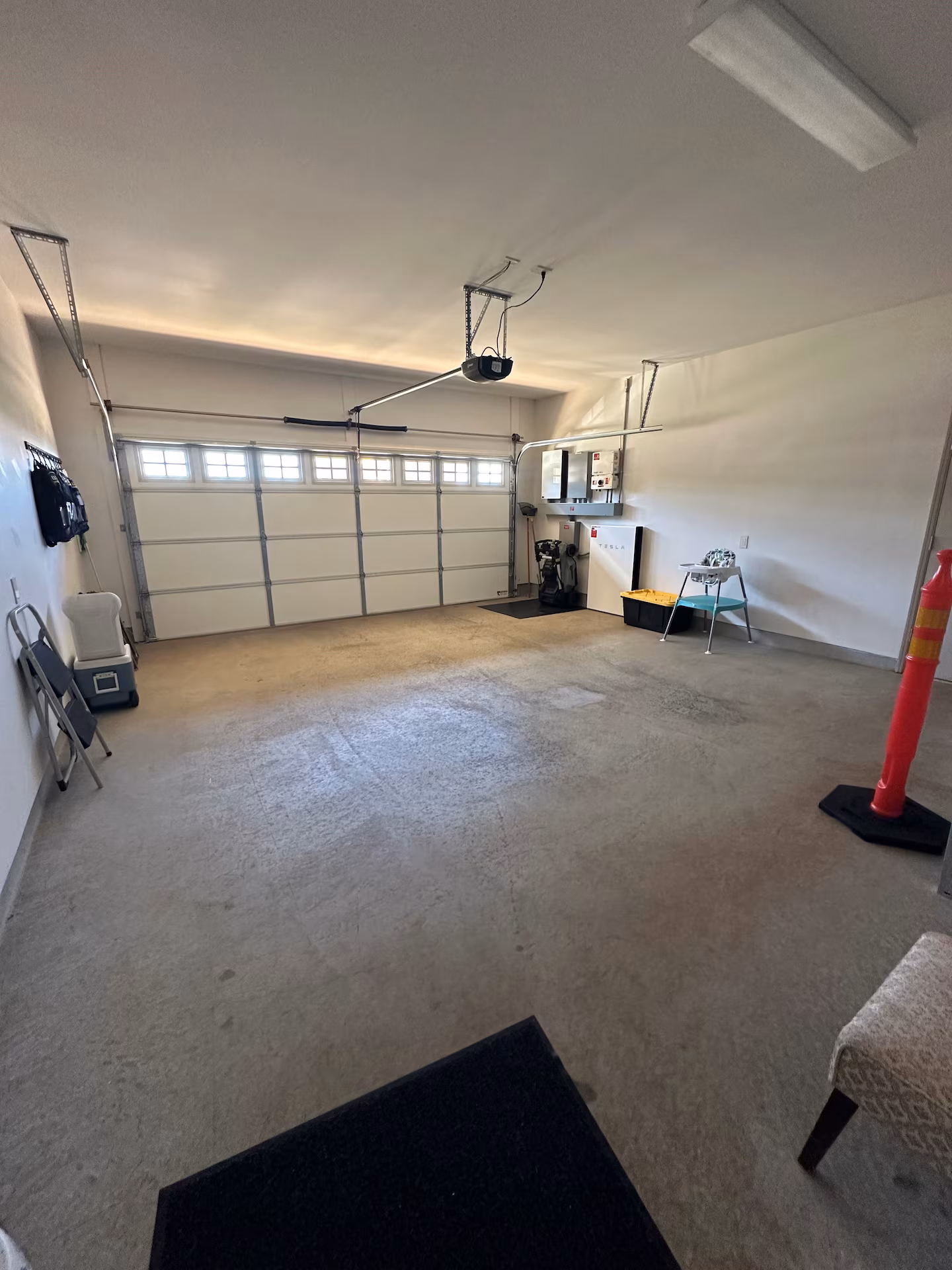 Two-car garage with a Tesla Powerwall on the wall