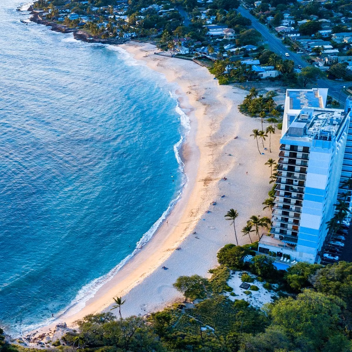 Aerial view of Papaoneone Beach curving along the Makaha shoreline, with the Hawaiian Princess building at the near end